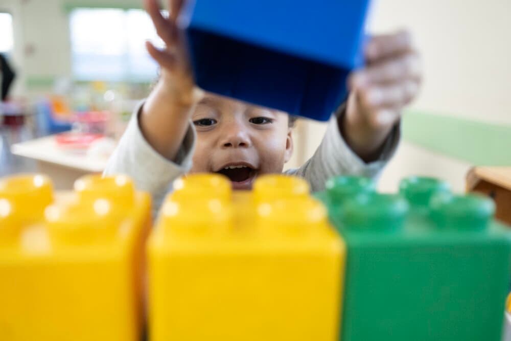 preschool child stacking blocks